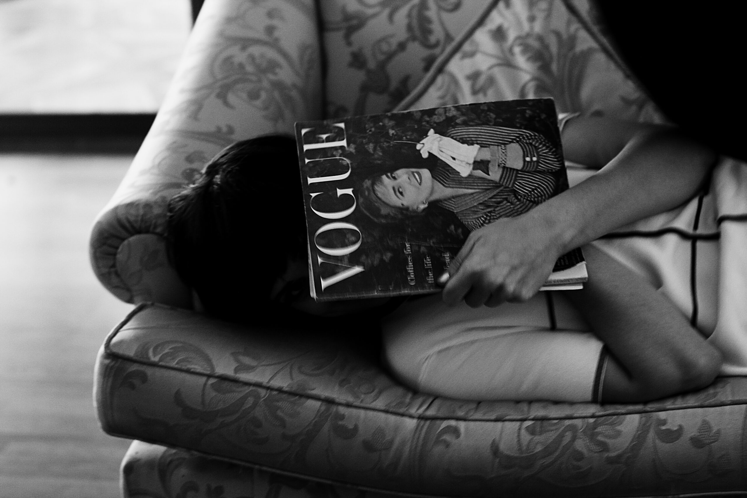 woman on couch with magazine